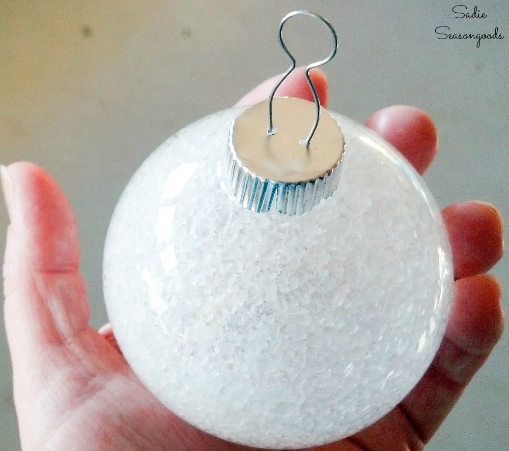 Placing an ornament cap on a clear ornament ball