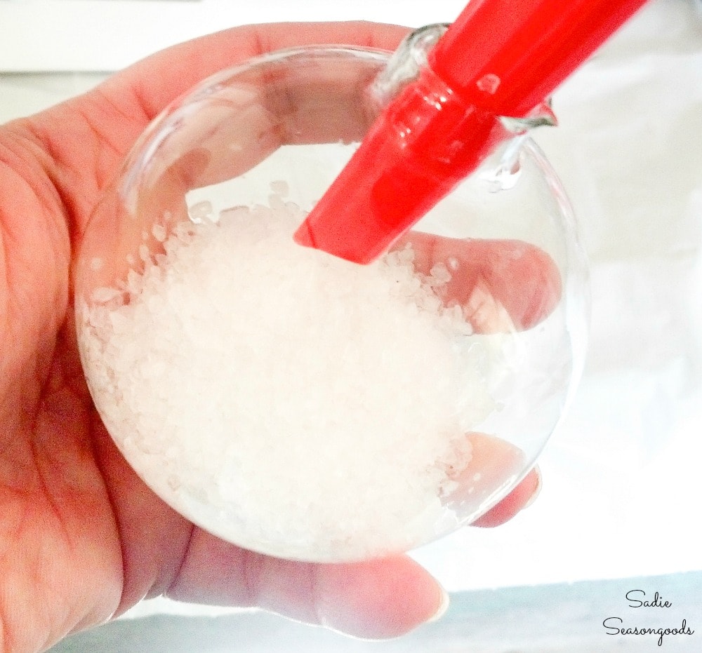 Using salt to make snow ornaments in clear ornament balls
