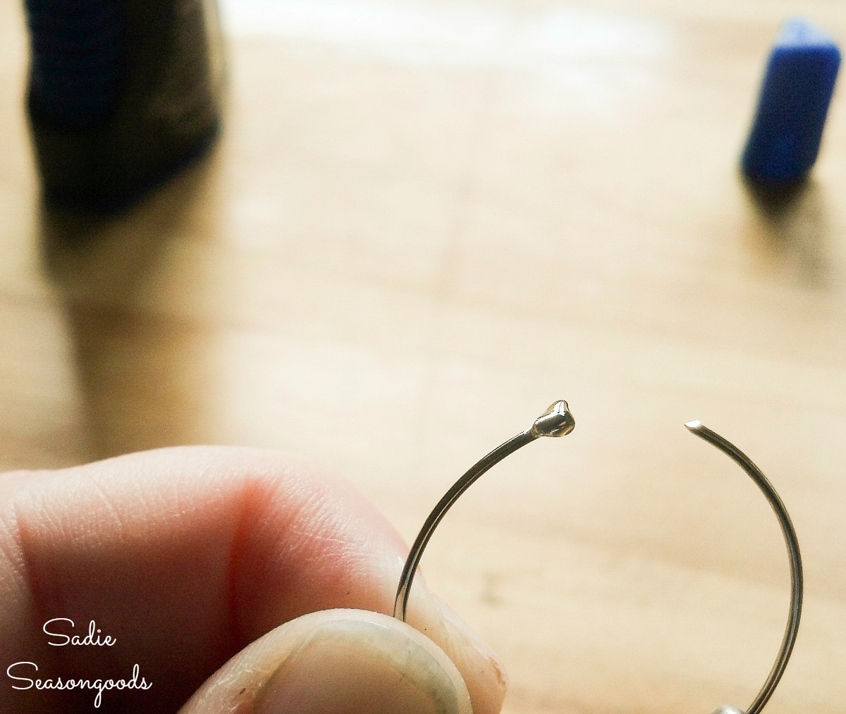 Gluing the beads on the end of the DIY wine glass charms