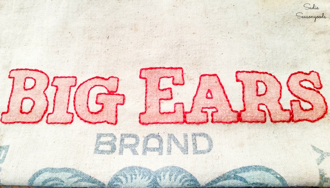 Embroidering a vintage feed sack