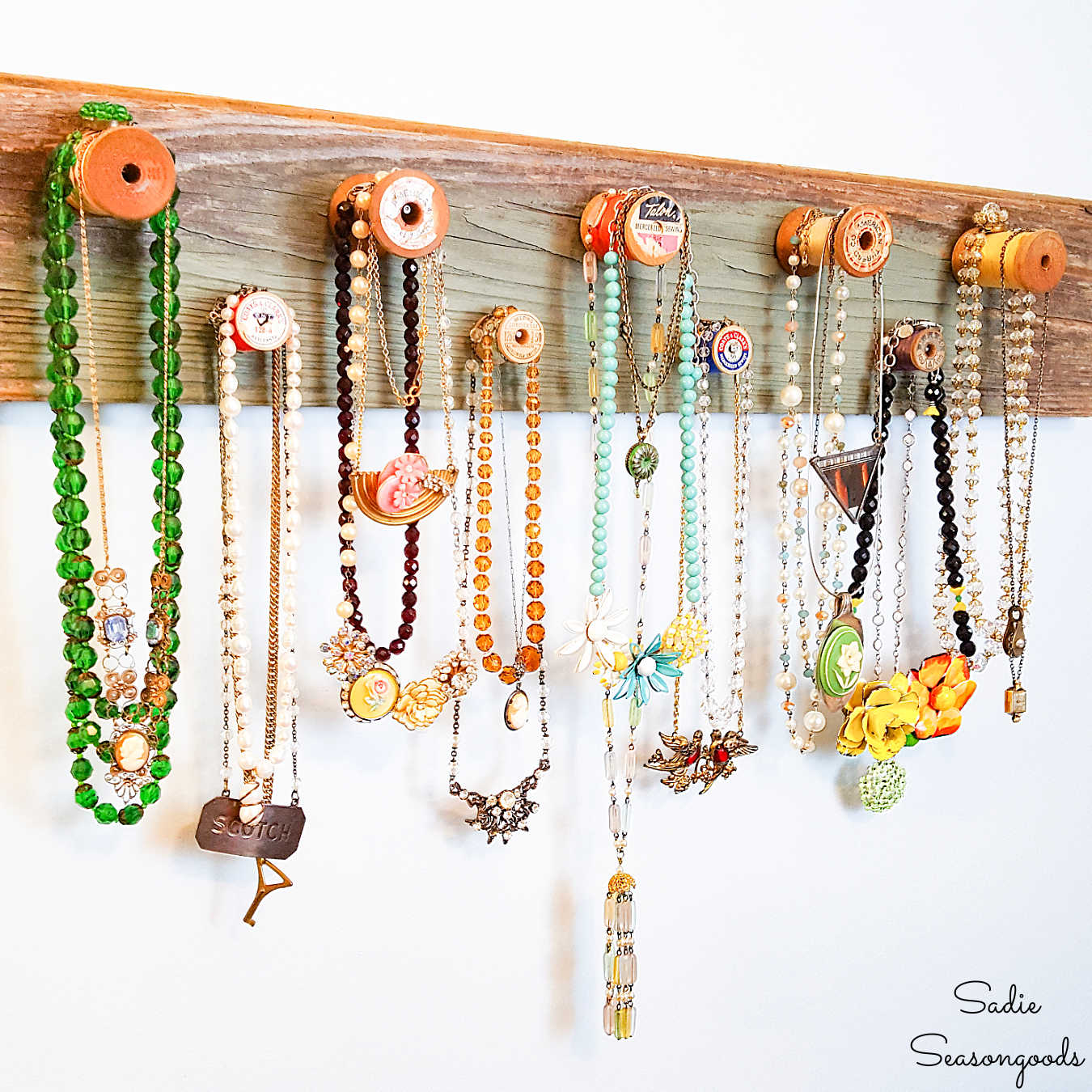 wooden necklace holder with vintage thread spools