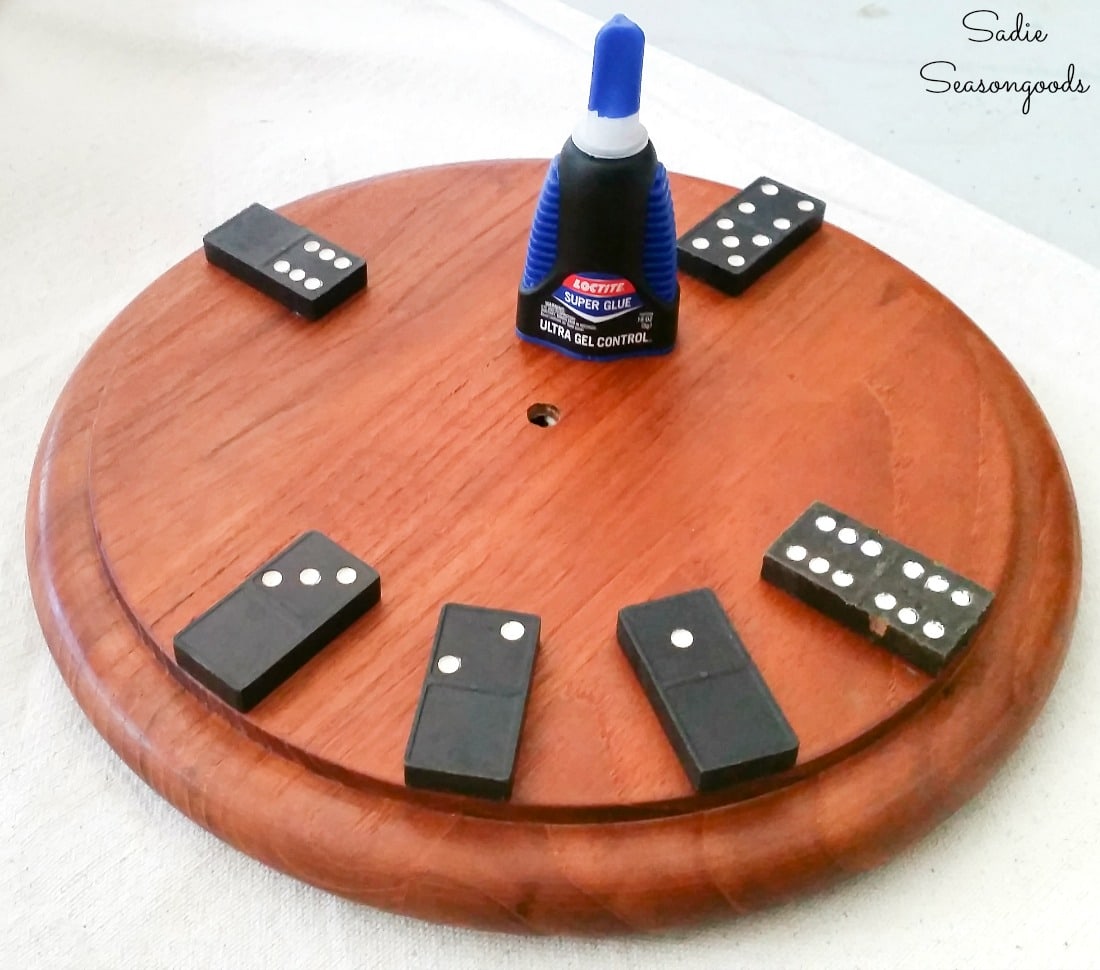 Gluing the vintage dominoes on a round cheese board