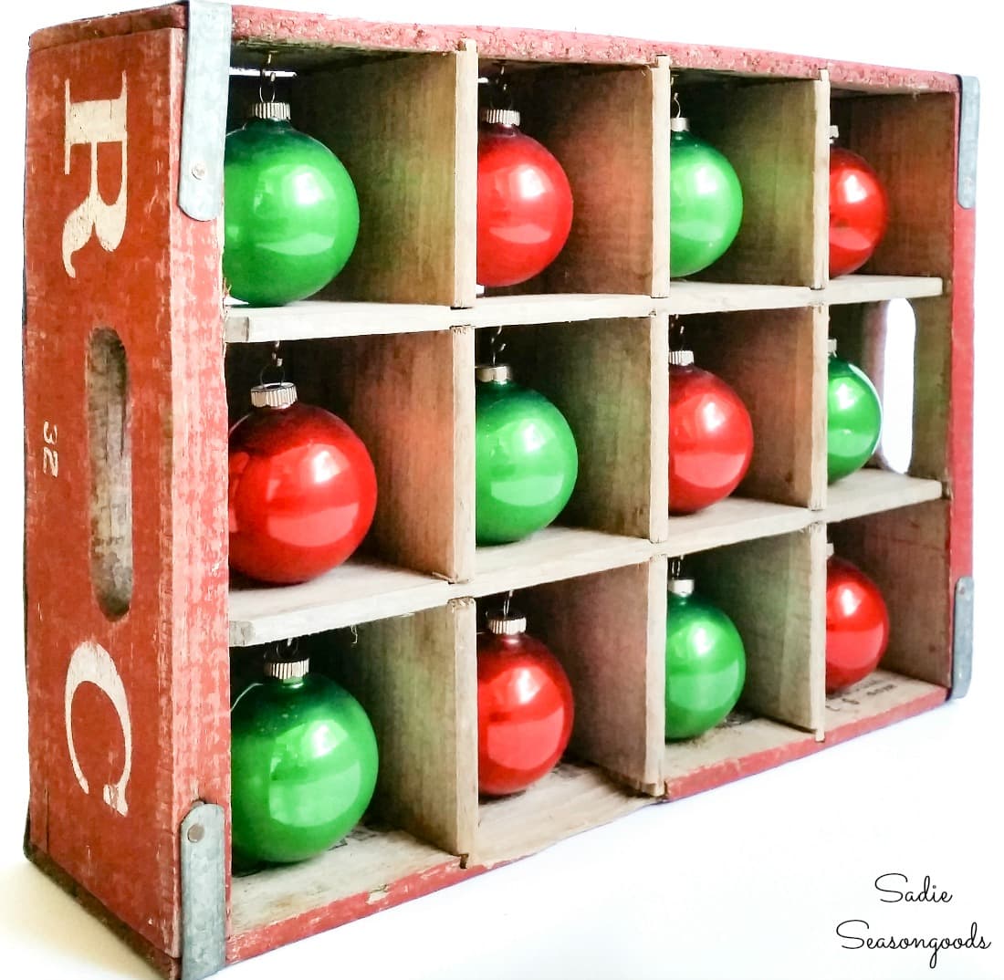 Shiny brite ornaments in a wooden bottle crate