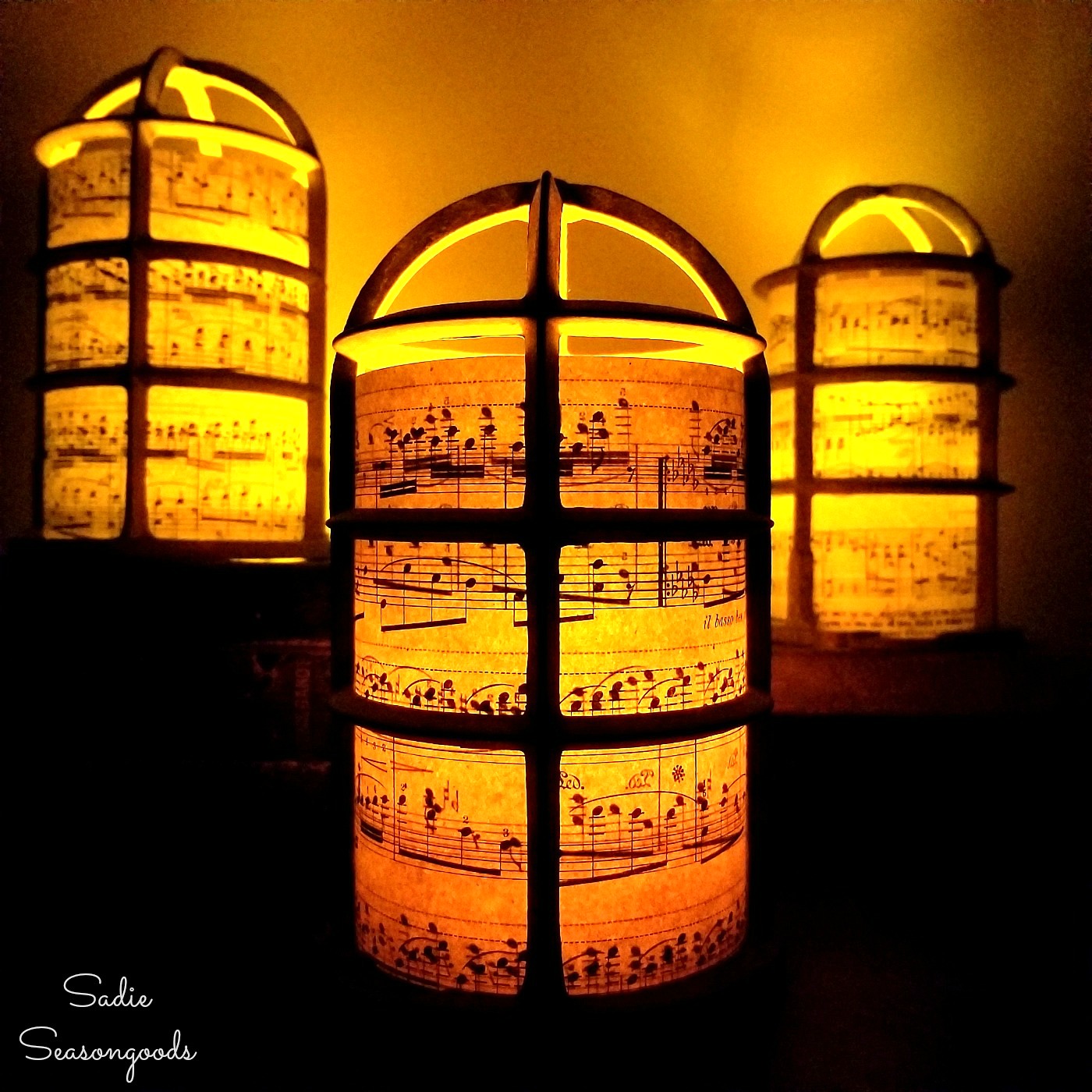 Christmas lantern for a rustic Christmas by upcycling the light bulb cages into luminaries with sheet music