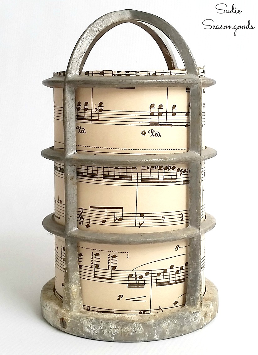 Repurposing the light bulb cages and vintage sheet music into the Christmas luminaries for rustic decor