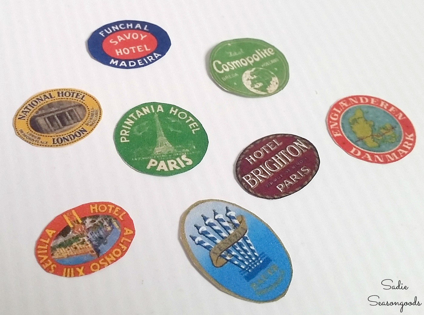 Travel stickers that are tiny to put on a mini suitcase from a mints tin to use as a Christmas ornament or unique travel gifts