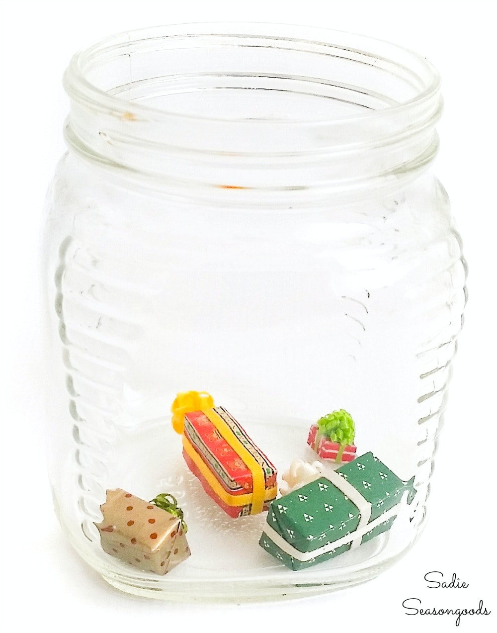 Filling a vintage glass jar to make a waterless snow globe