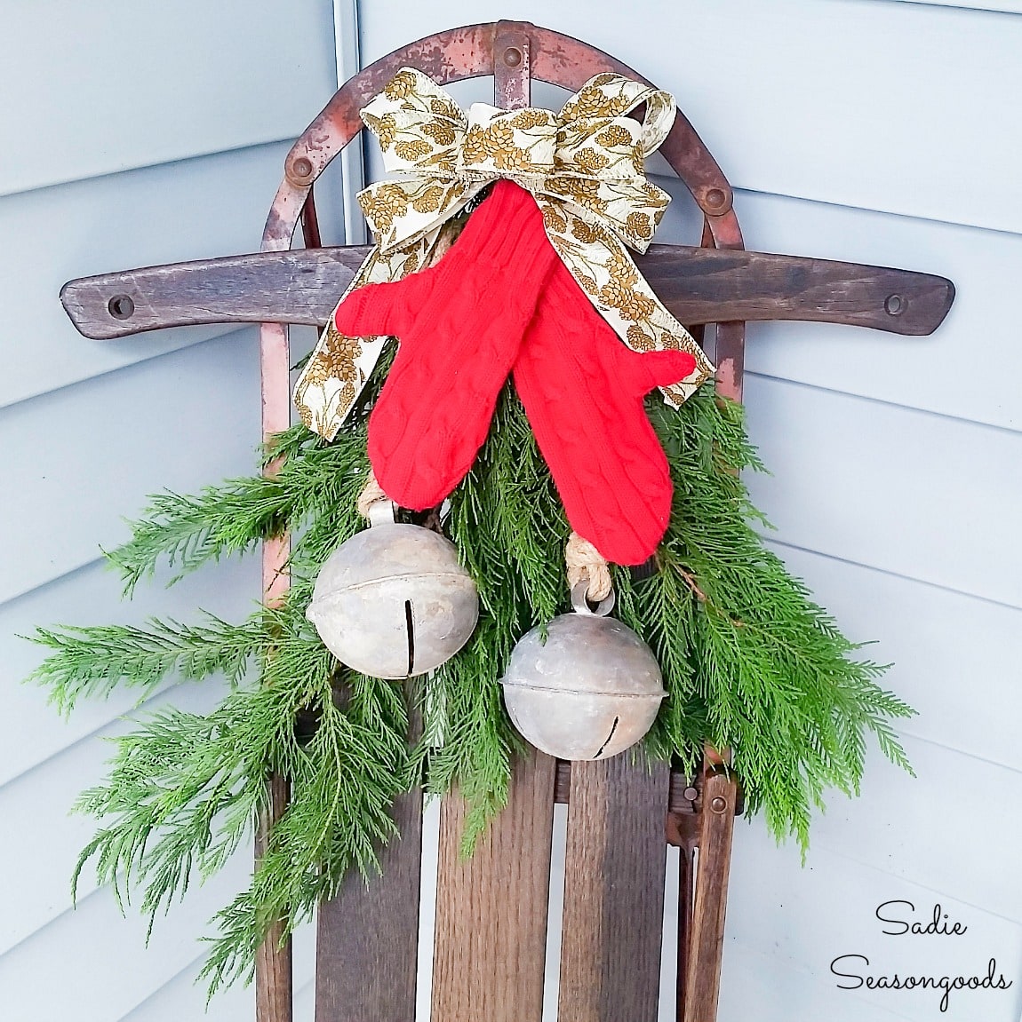 Wooden sled decor with sweater mittens