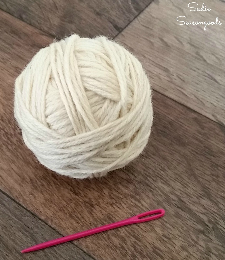 Using an embroidery needle to hide the yarn tail in a yarn ball or dryer balls by Sadie Seasongoods