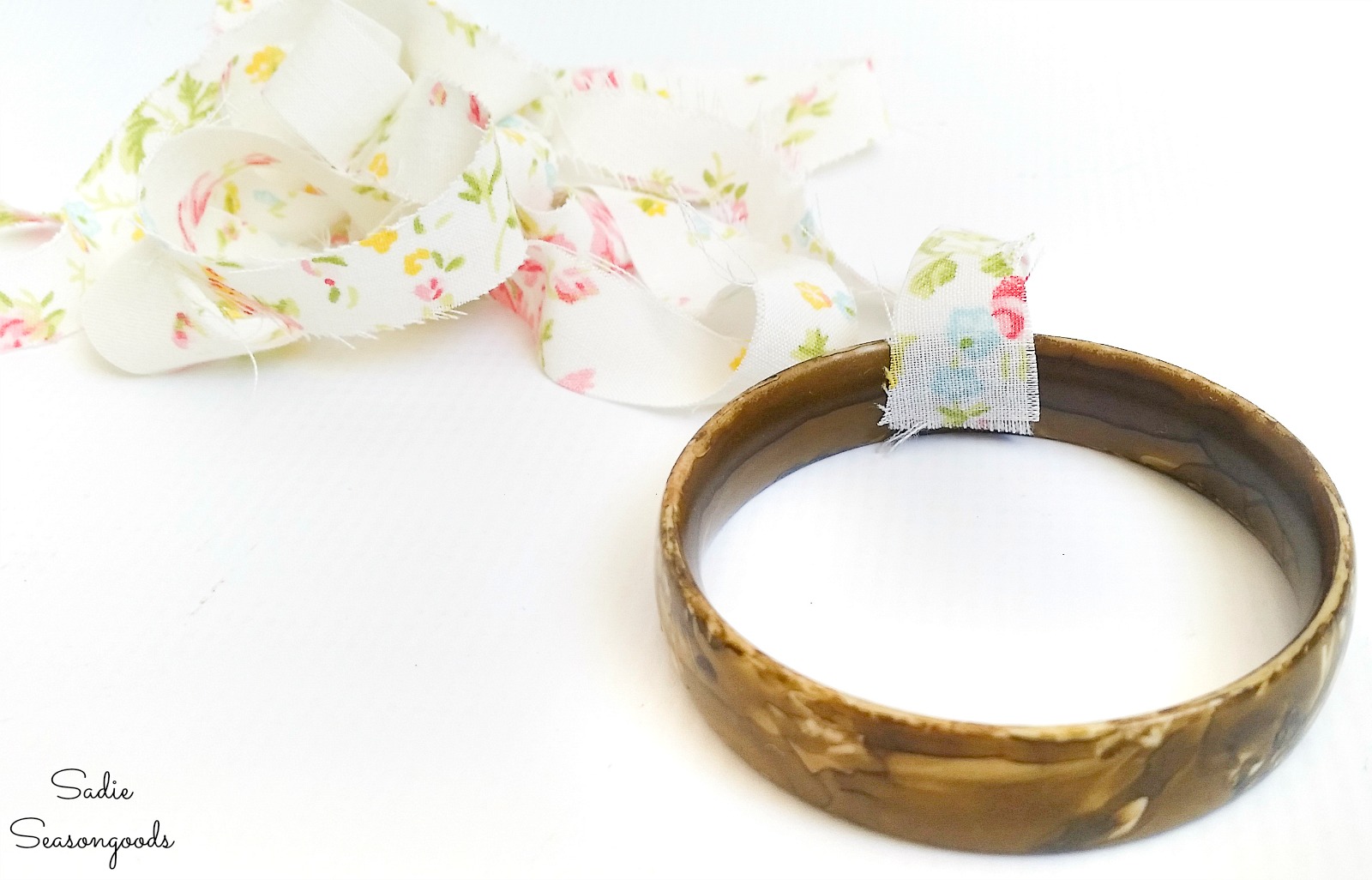 Wrapping the plastic bangles with vintage fabric