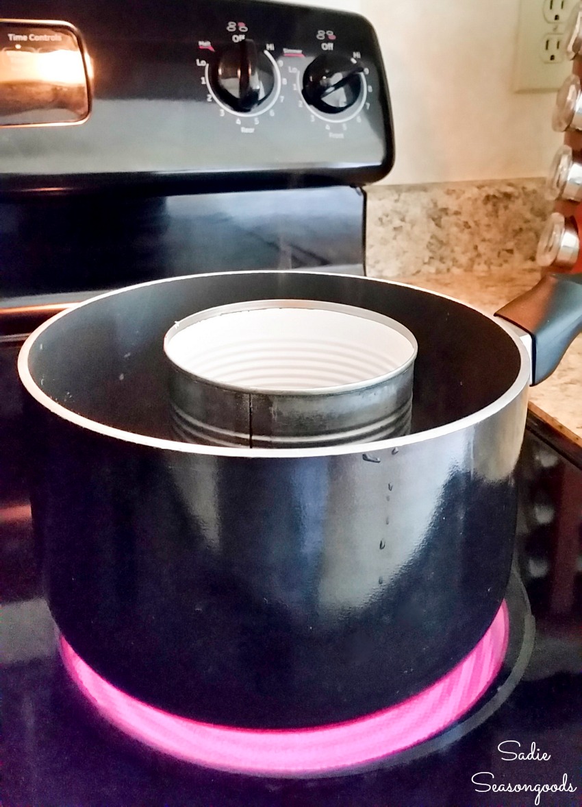 Melting the local beeswax in a double boiler with a tin can