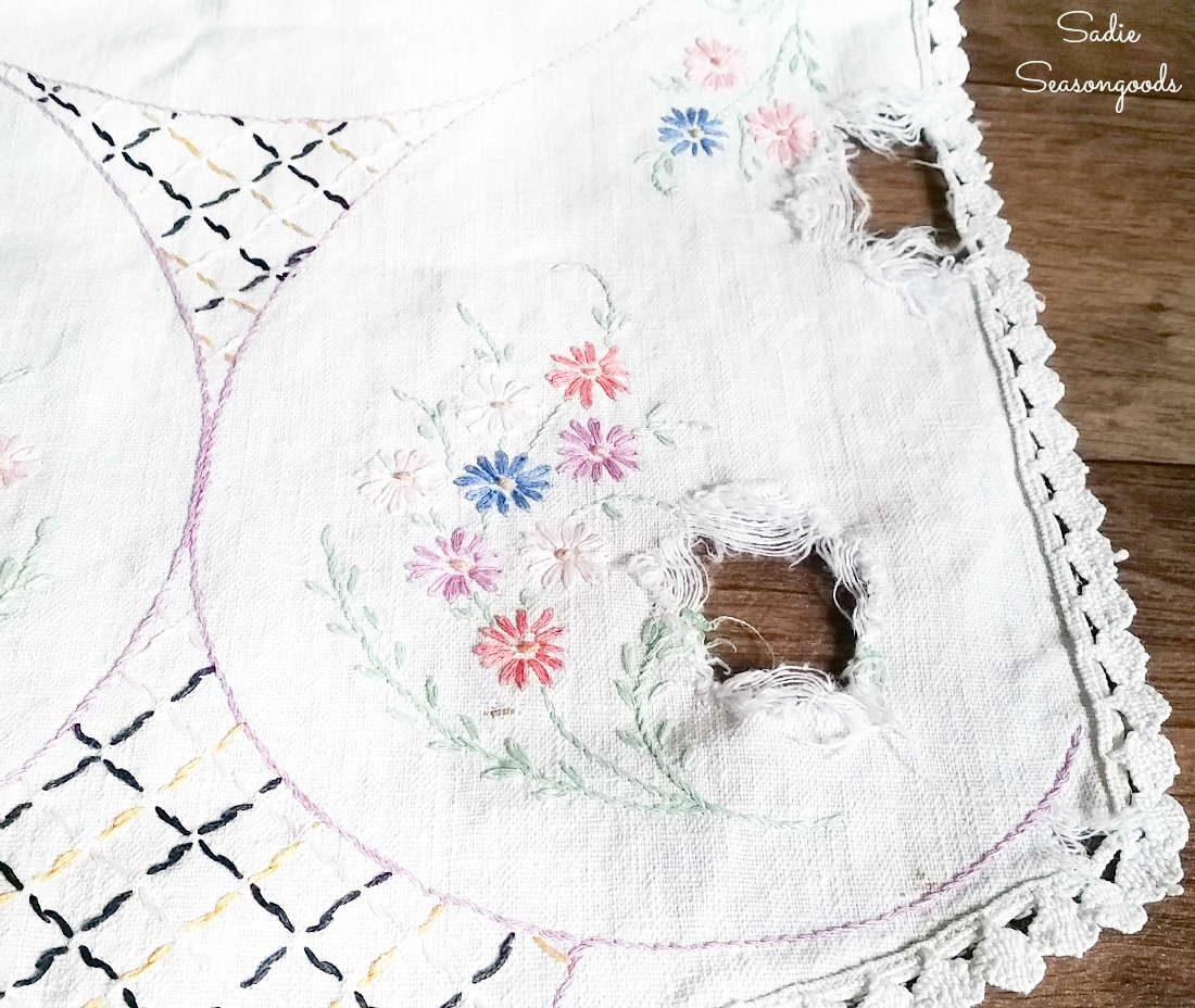 Vintage embroidery with holes and tears for upcycling projects