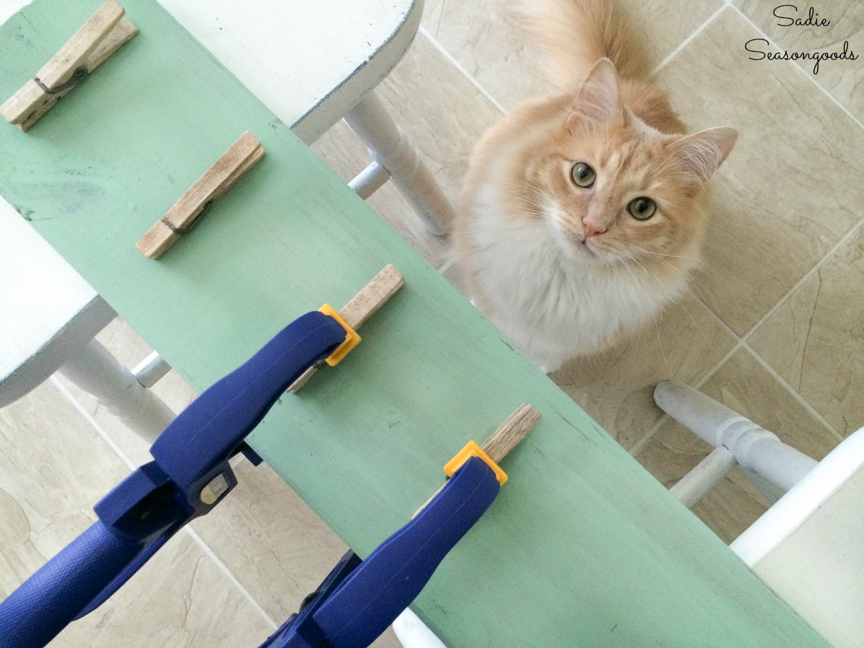 Gluing the wood clothespins for a DIY Clipboard