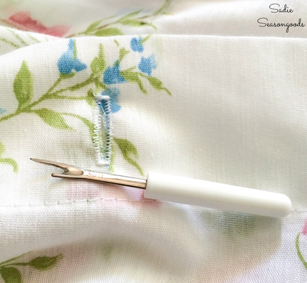 Sewing buttonholes on a cloth shower curtain from vintage bed sheets