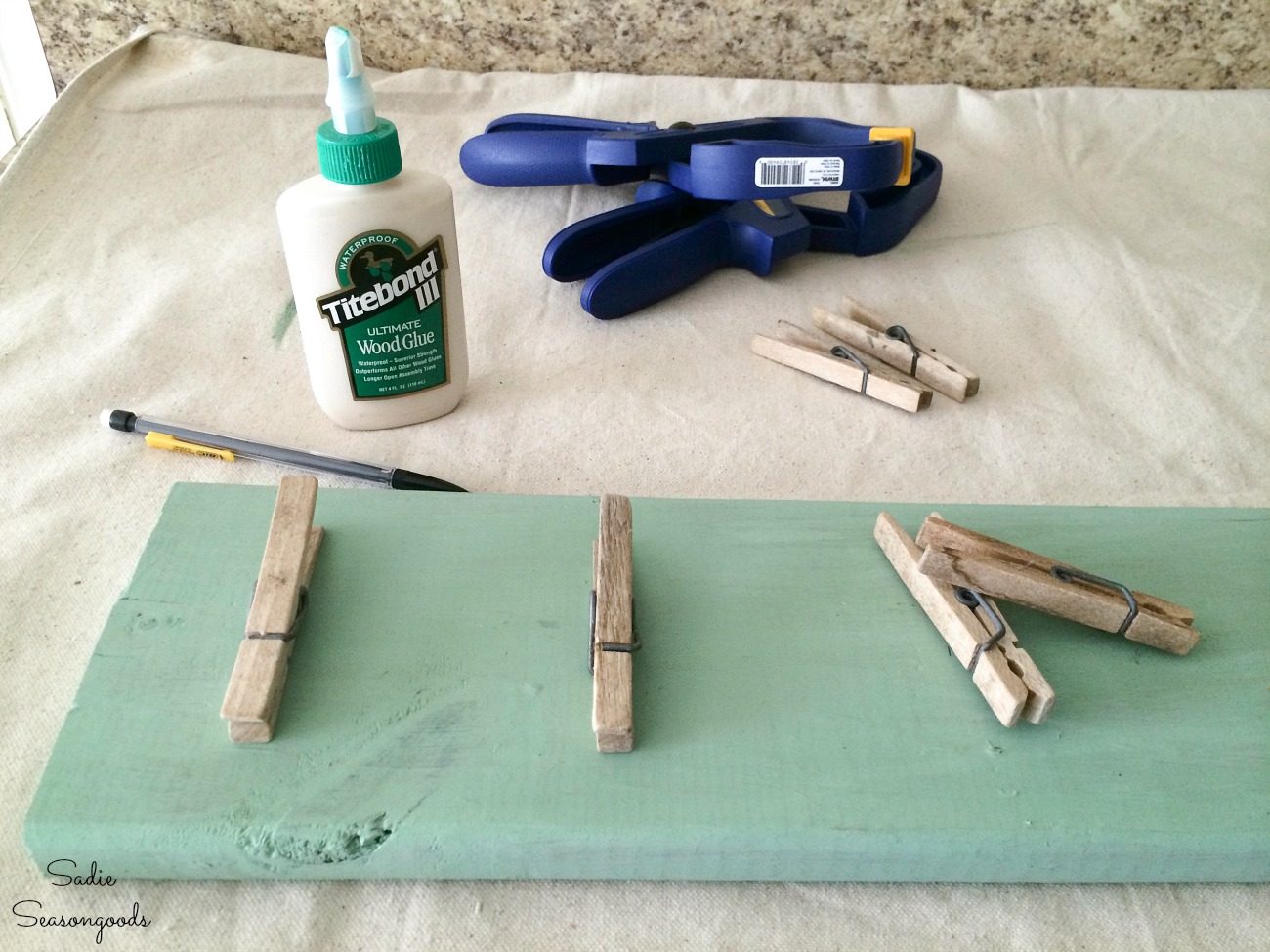 Spacing out the wood clothespins for a garage wall organizer