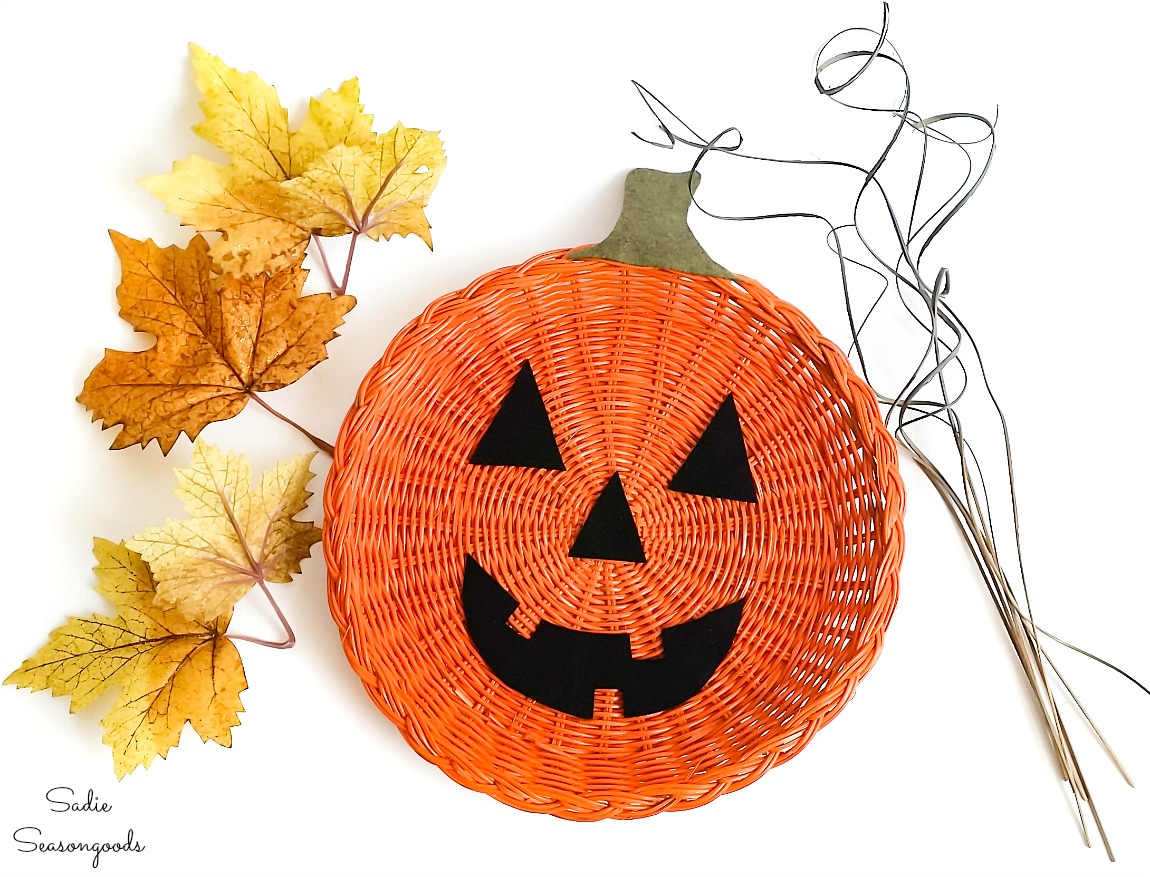 Decorating a Halloween door hanger with leaves and vines