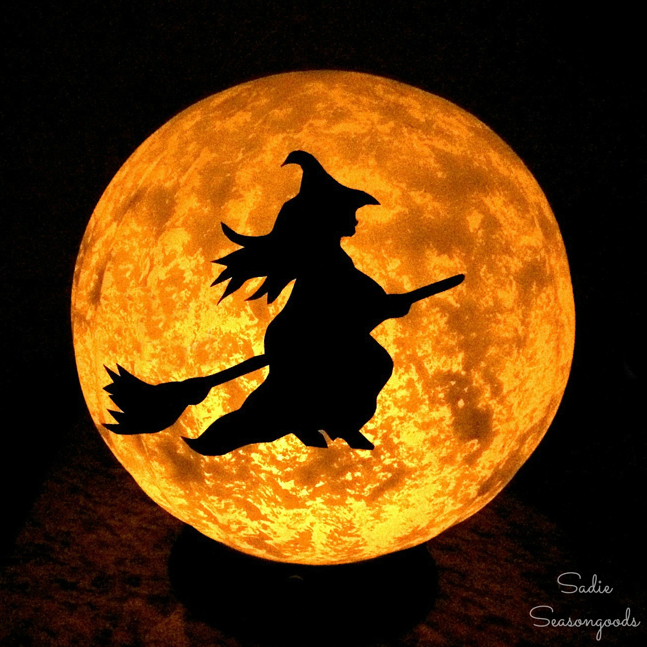 Halloween Moon And Witch Decorations With A Vintage Light Fixture