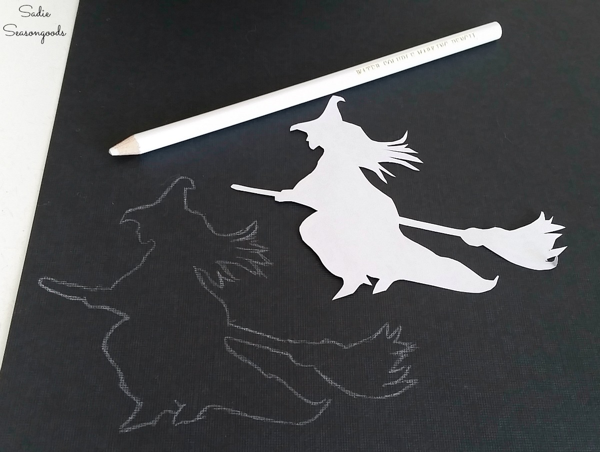 Tracing a flying witch on black cardstock paper