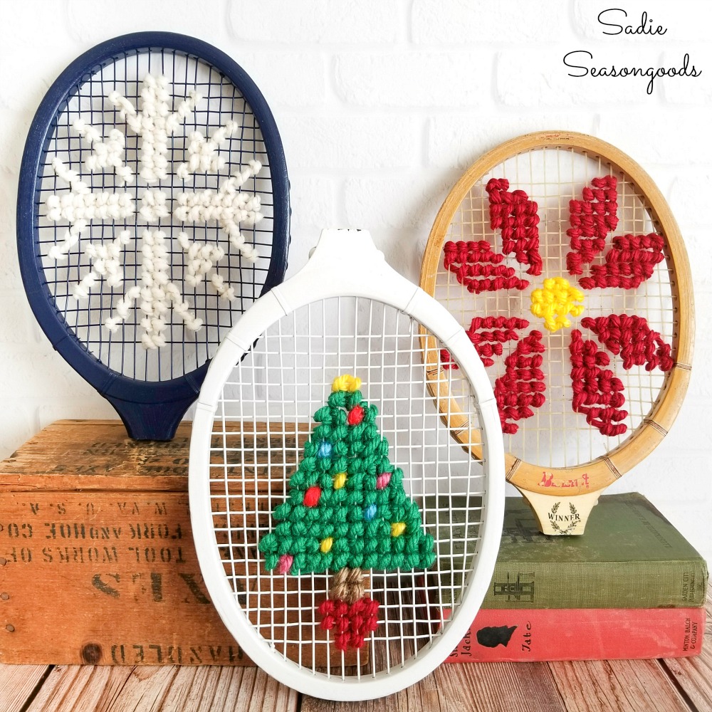 Christmas cross stitch on the heads of vintage tennis rackets