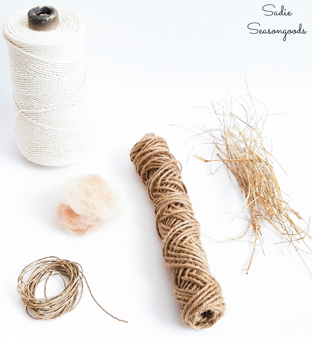 Nesting material for wild birds with untreated pet fur and cotton string and dried grass