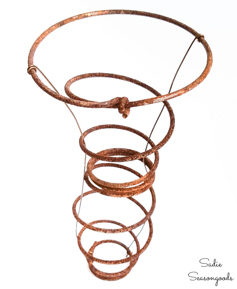 Rusty spring with jewelry wire on the sides to hold the nesting material