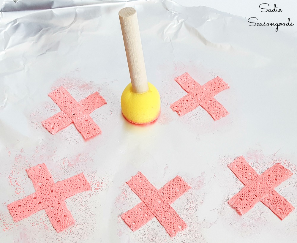 Game pieces for a tic tac toe board with a wooden cake stand