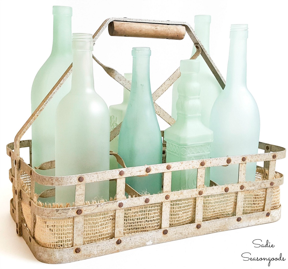 Sea glass bottles in a milk bottle basket as coastal decor