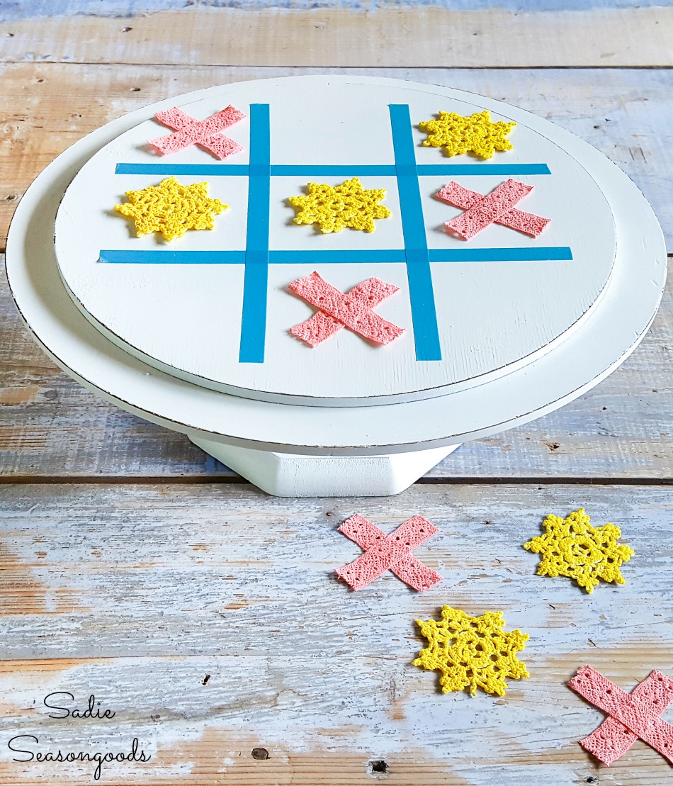 Thrift store makeovers with a wooden cake stand as a tic tac toe board