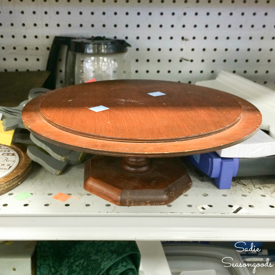 Wooden cake stand at a thrift store for upcycling into a game board