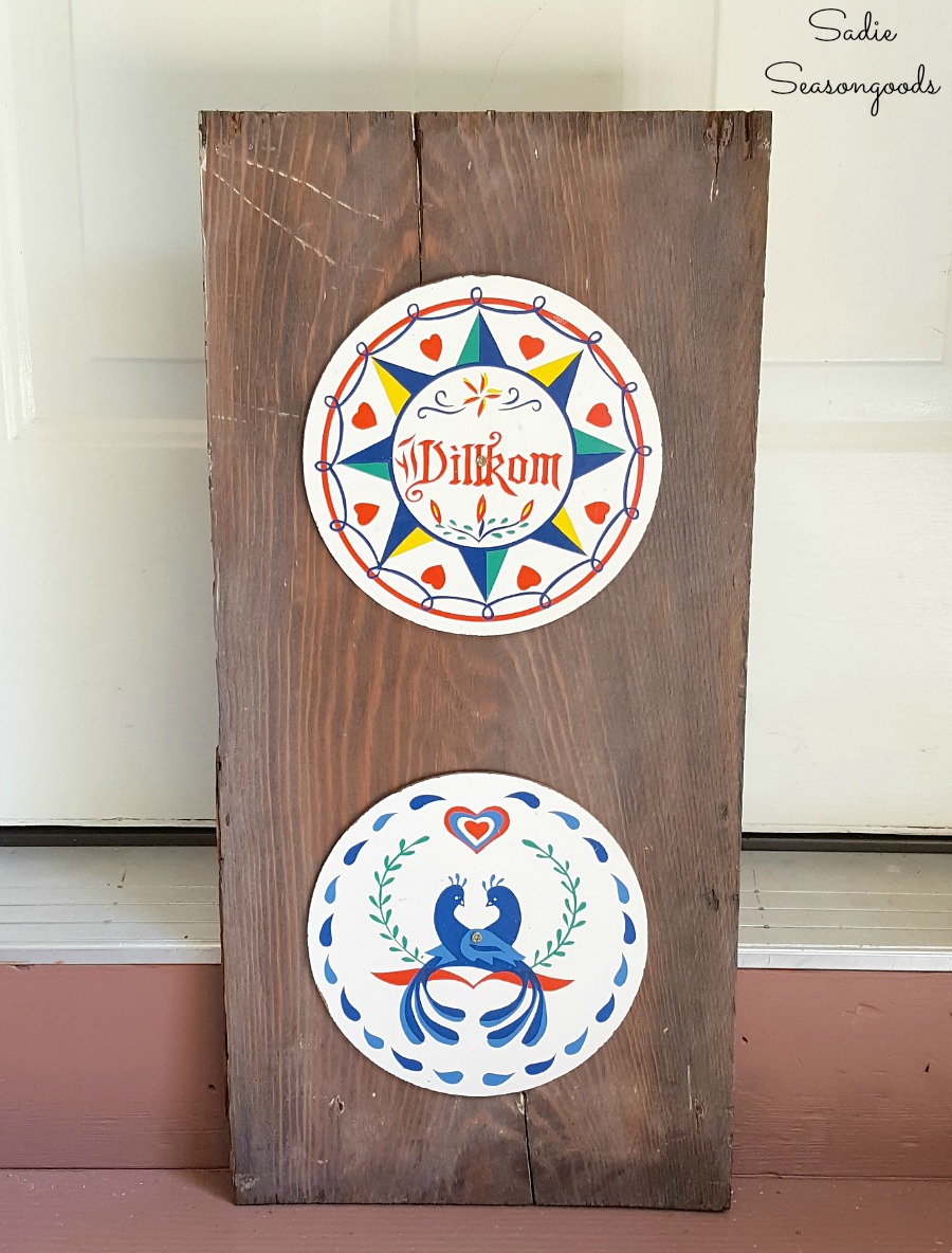 Outdoor wall decor with hex signs attached to salvaged wood to hang on tool shed by Sadie Seasongoods