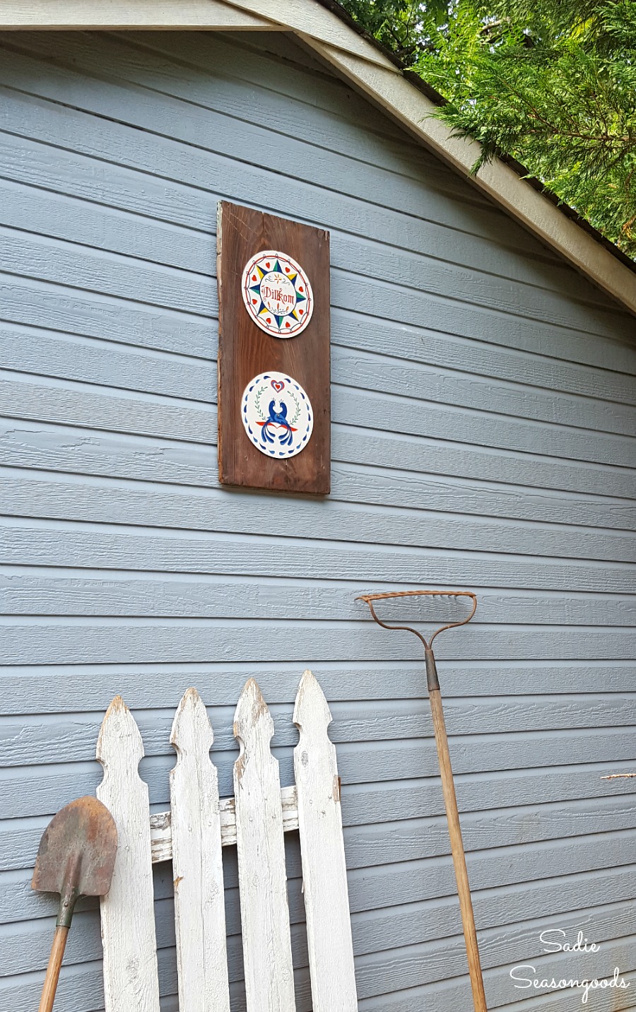 Hex signs displayed on a tool shed to look like barn decor or outdoor wall decor by Sadie Seasongoods