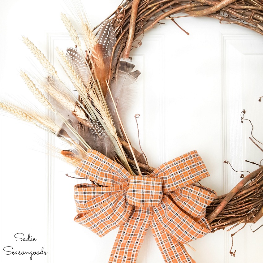 Harvest wreath with a bow made from plaid ribbon