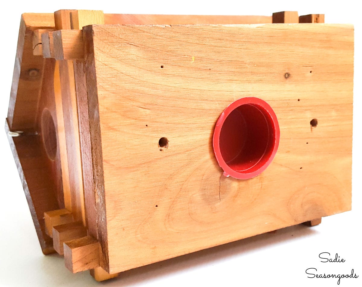 Drilling drainage holes in a log cabin birdhouse