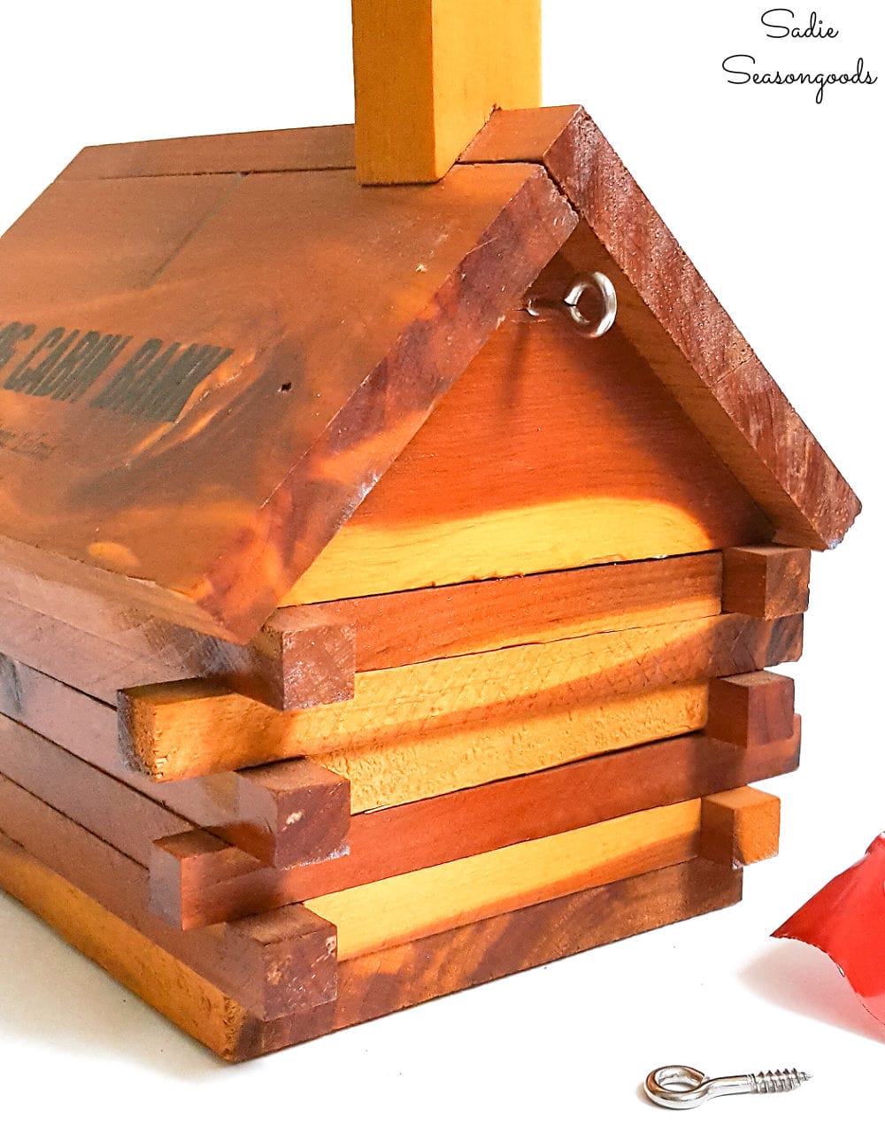 Hanging a log birdhouse from a vintage coin bank