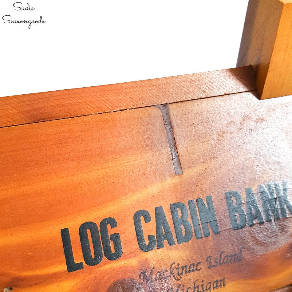 Upcycling a vintage coin bank as a log cabin birdhouse