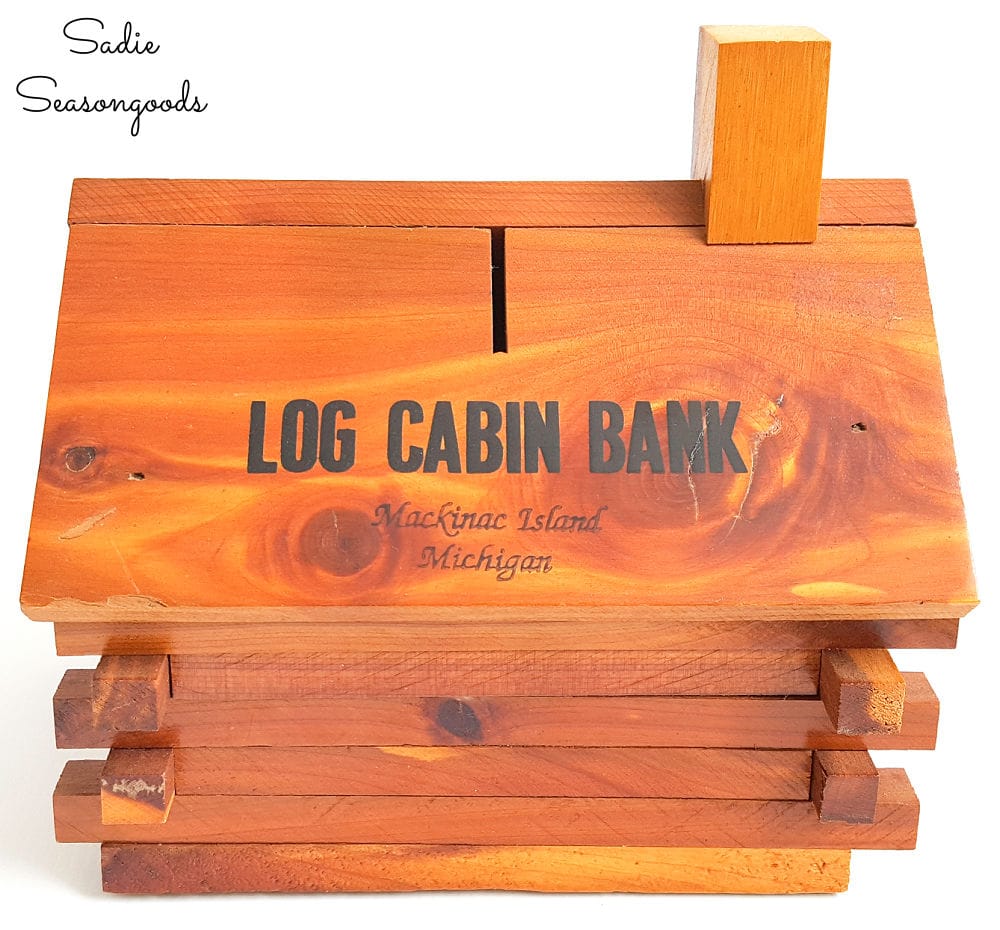 Vintage coin bank in the shape of a cabin