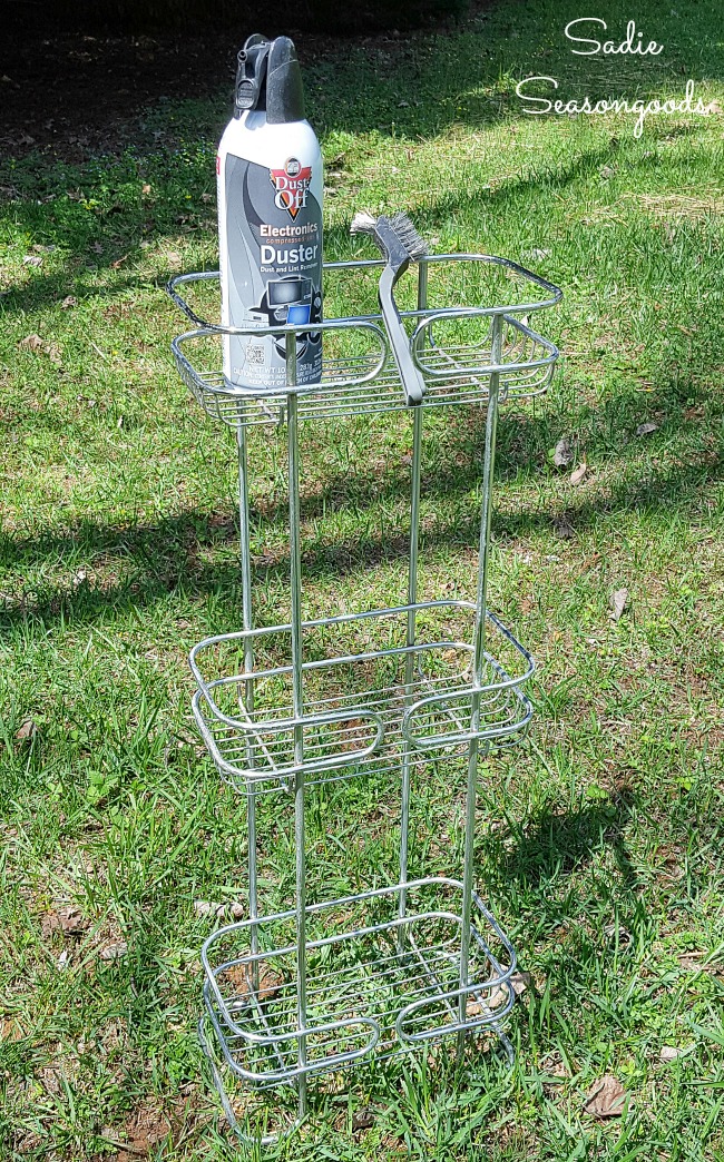 Cleaning a standing shower caddy with a wire brush before spray painting metal