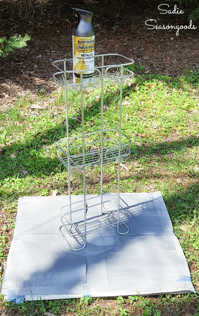 Spray painting metal of a shower basket for upcycling as a porch garden