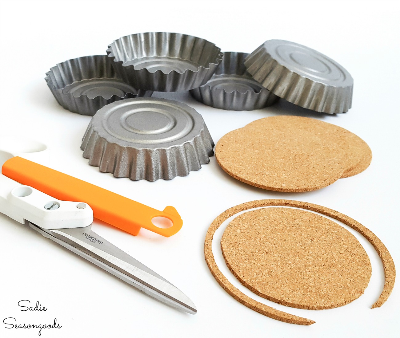 Trimming the cork coasters to fit in the tart tins