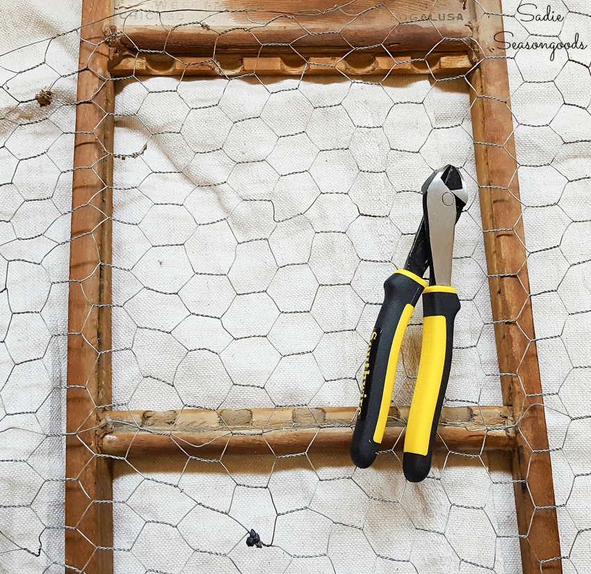 Attaching the chicken wire to an old washboard for primitive farmhouse decor