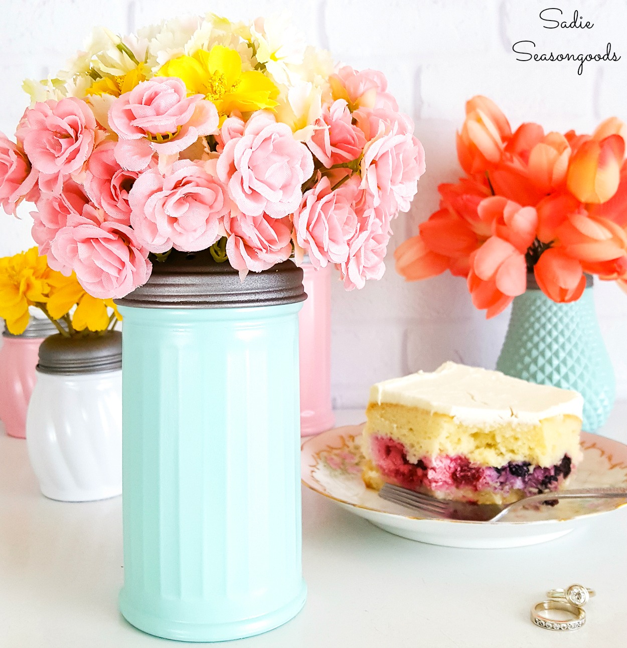 Cheese shakers as pink milk glass with a flower frog from the shaker top