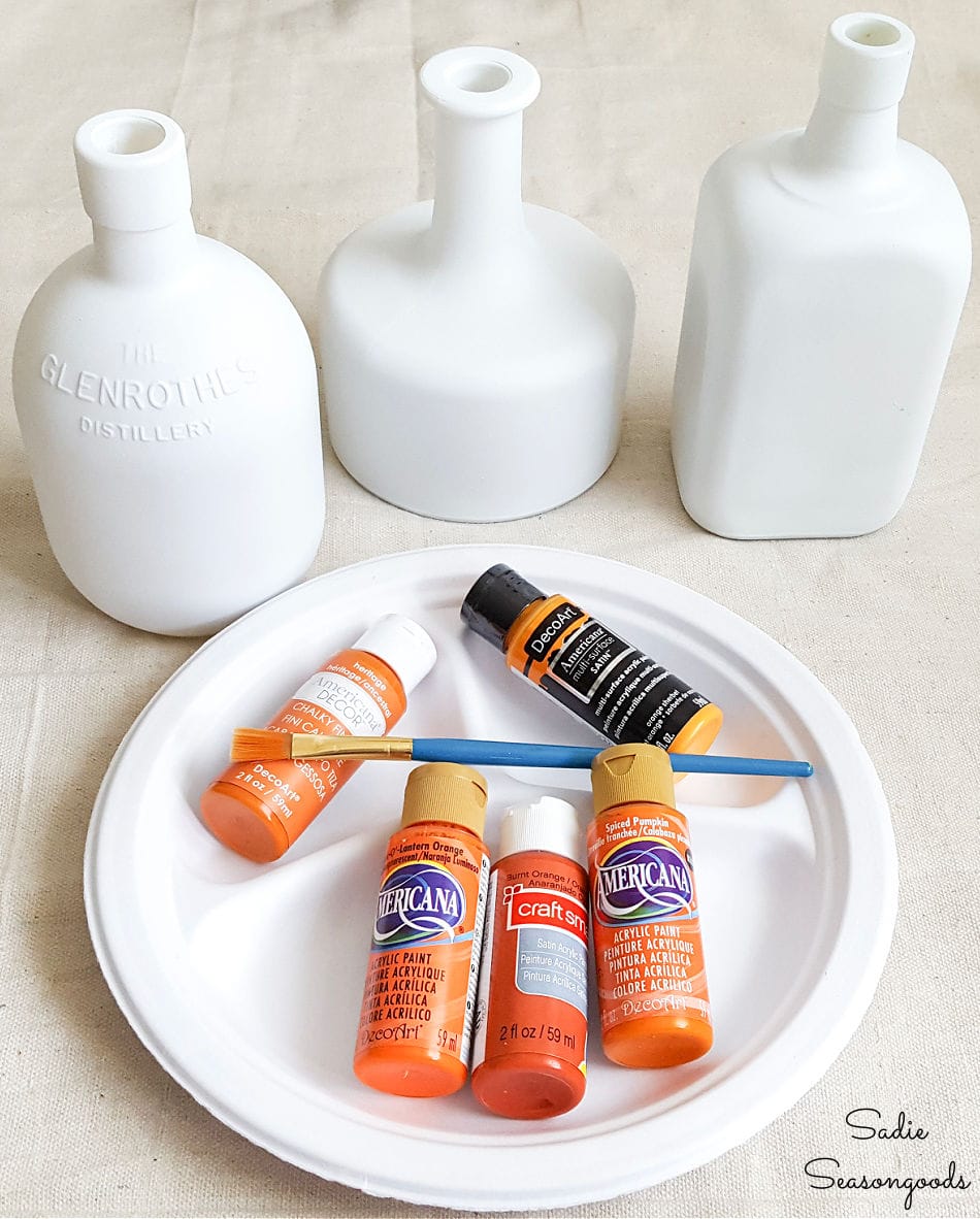 glass bottle painting to look like pumpkins