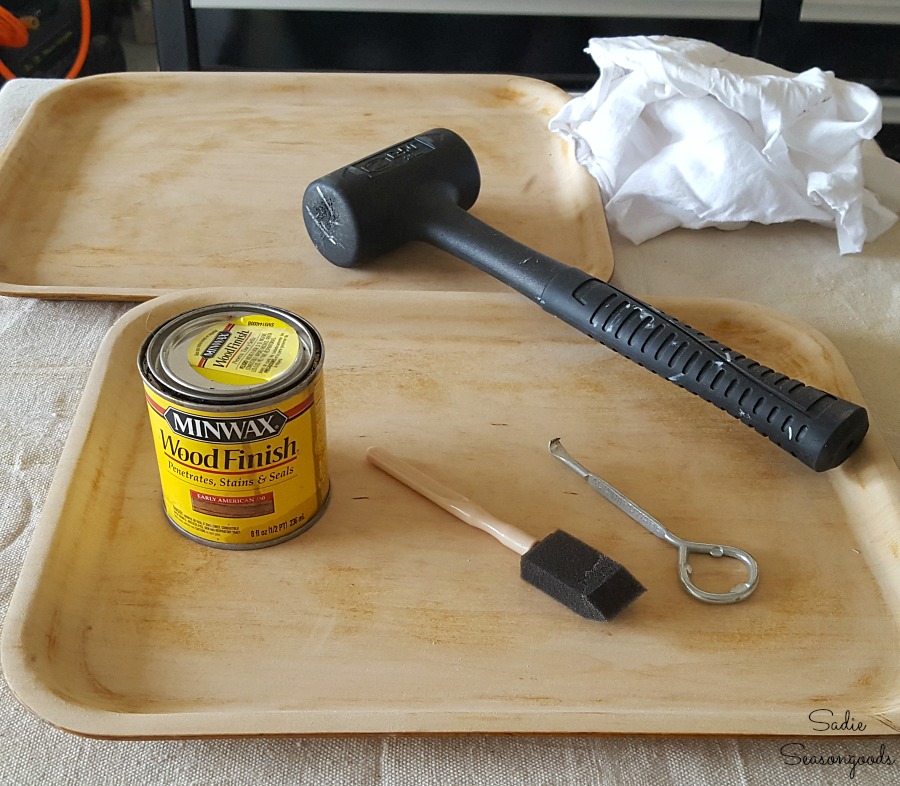 Using wood stain on wooden tray to repurpose it into rustic cabin decor with a Buffalo check stencil