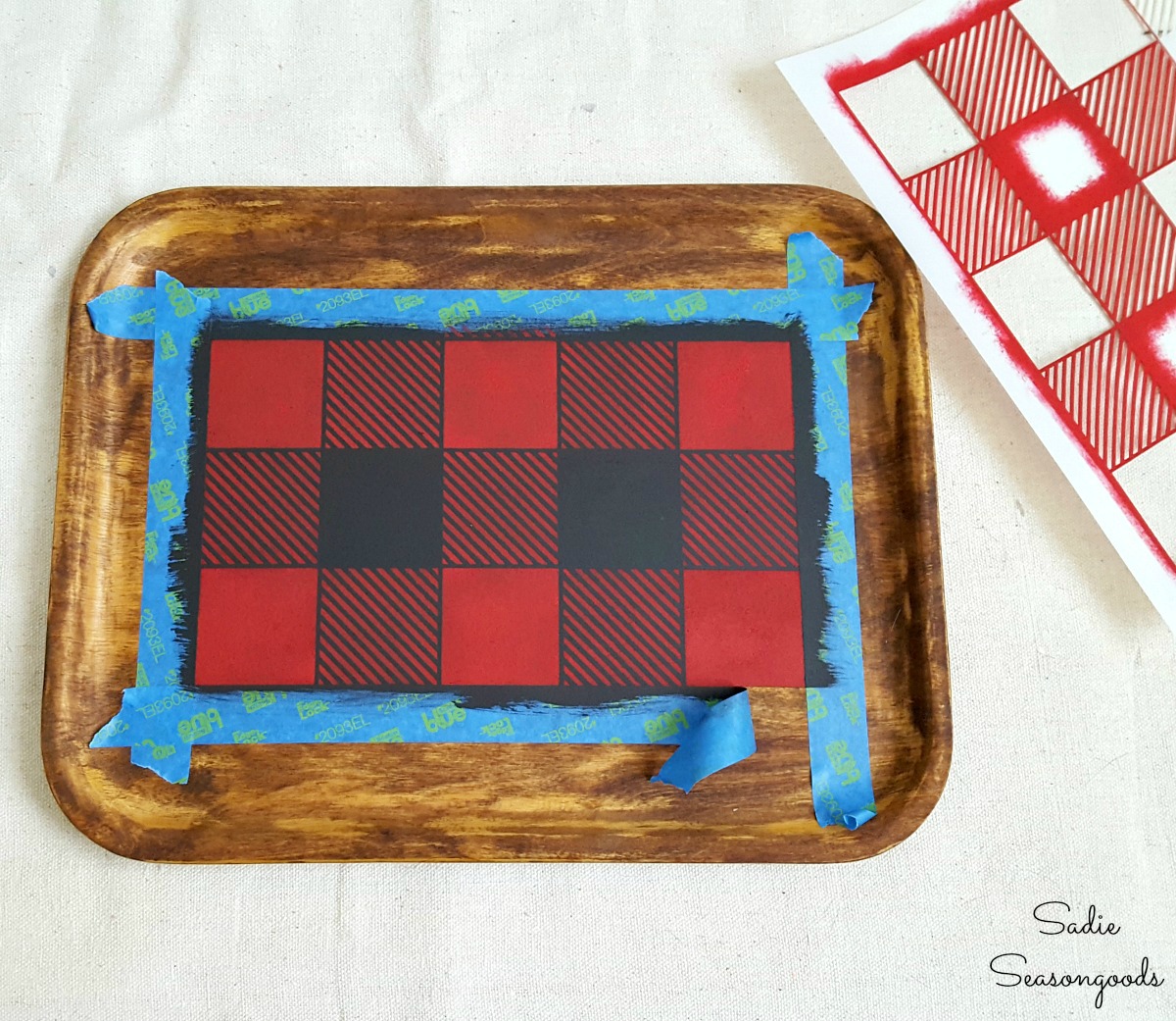 Using a Buffalo check stencil or Buffalo plaid stencil on a wooden tray to create the rustic cabin decor