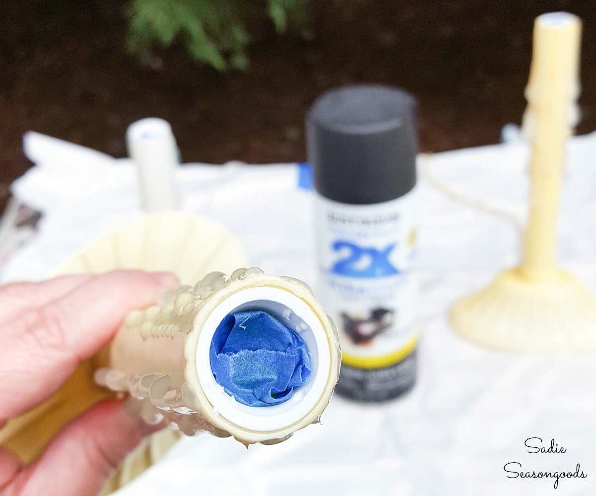 Spray painting the Electric Christmas Candles with black paint