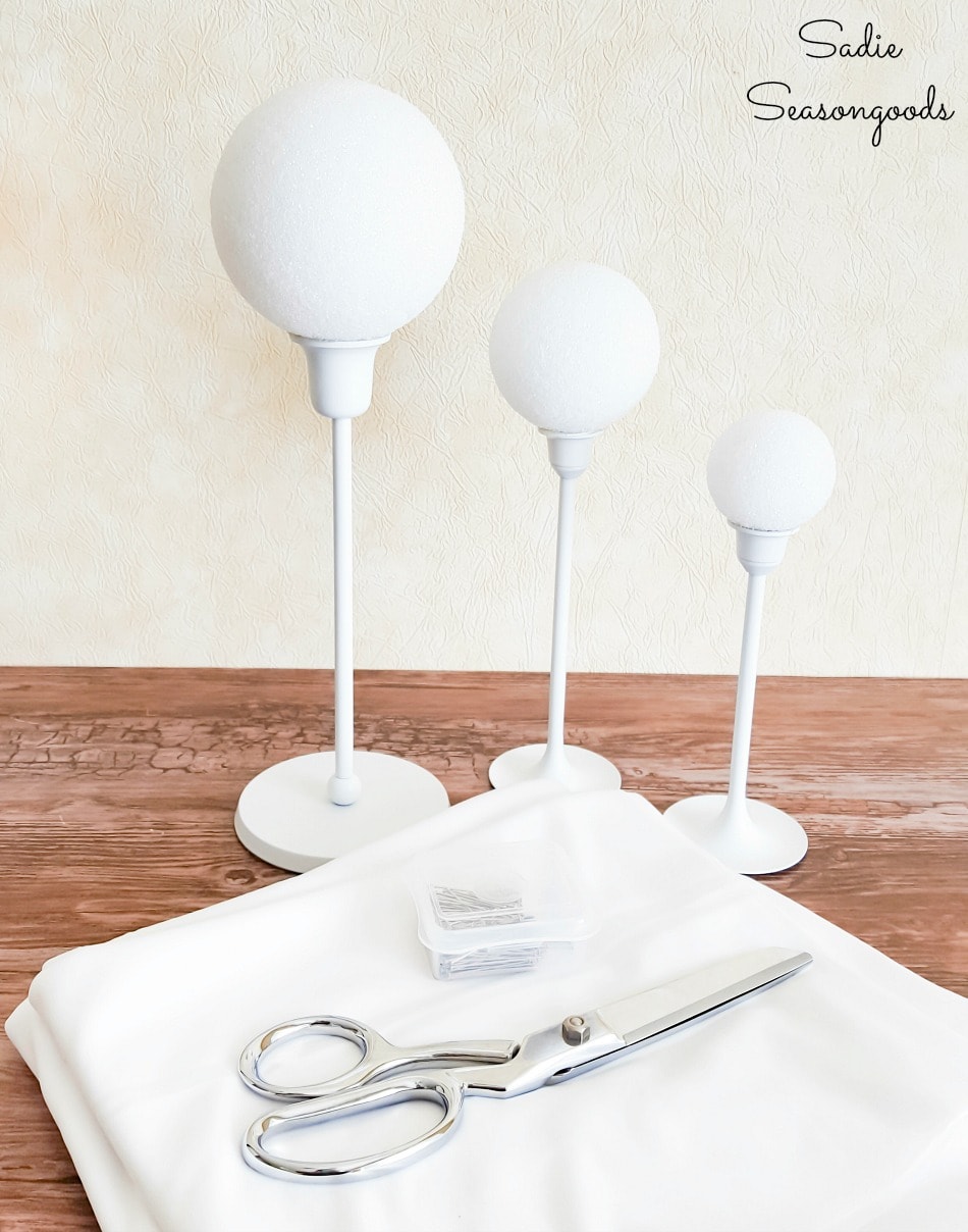 Ghost crafts with brass candlesticks and white fabric