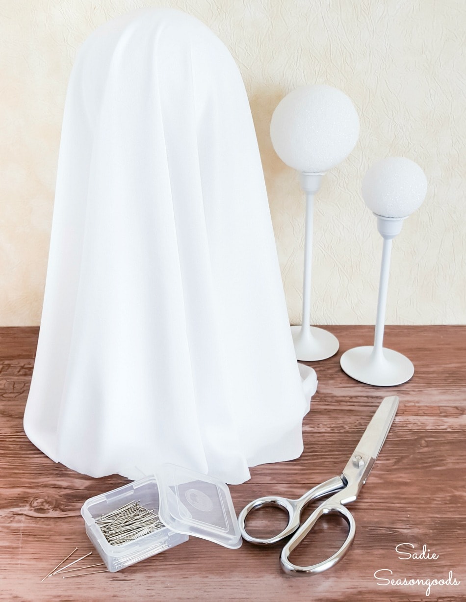 Halloween ghost decor with styrofoam balls and brass candlesticks