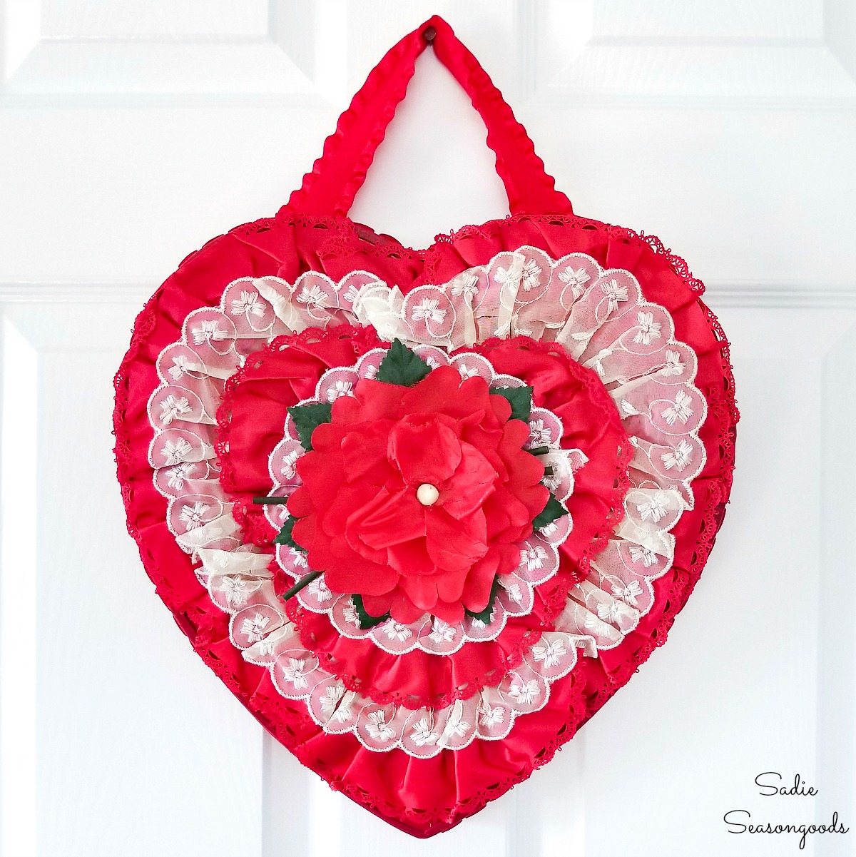 Heart shaped wreath as vintage Valentines decorations with a chocolate heart box