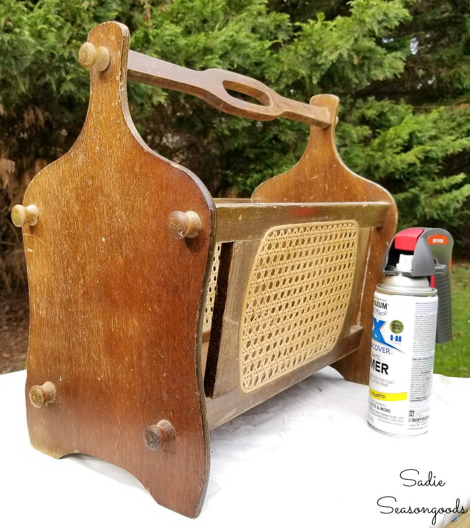 Spray painting a vintage magazine rack for upcycling