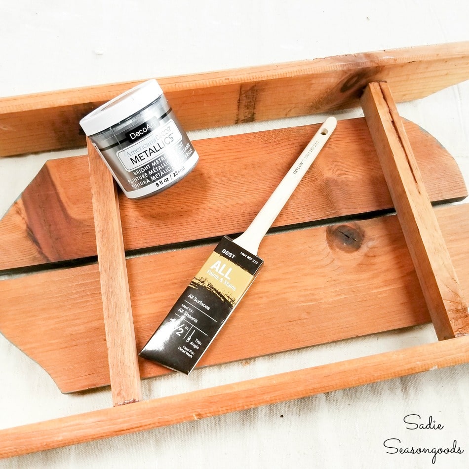 Painting the rails on wooden sled decor